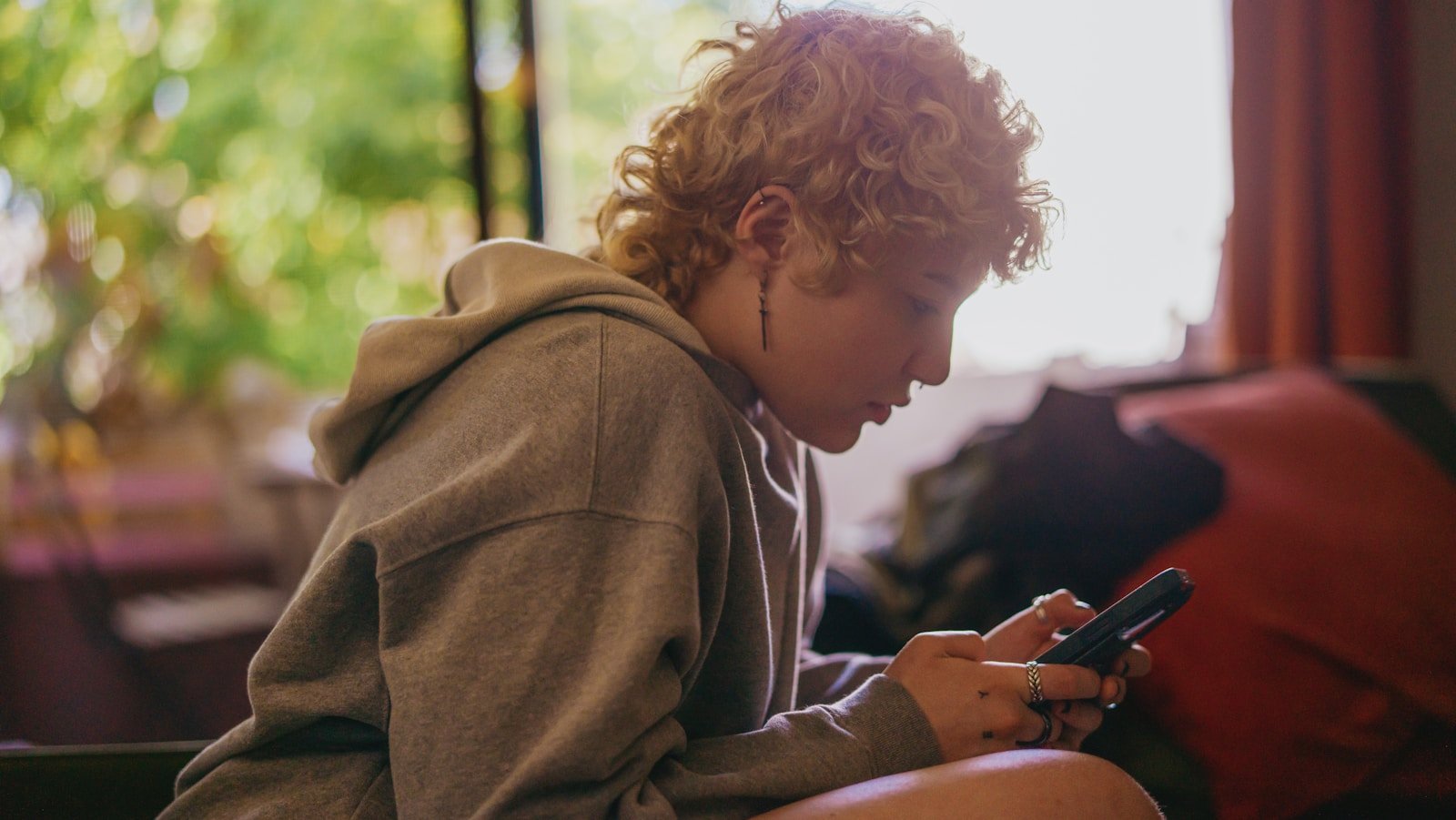 Portrait of an ADHD person using their mobile phone indoors