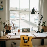 a yellow backpack sitting on top of a wooden table